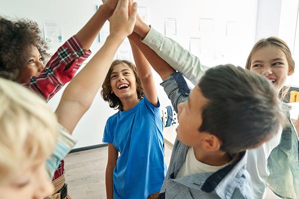 Group of kids high-fiving