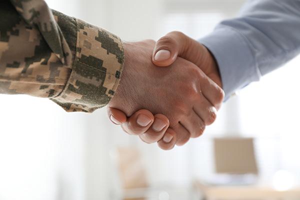 Veteran shaking hands with another person